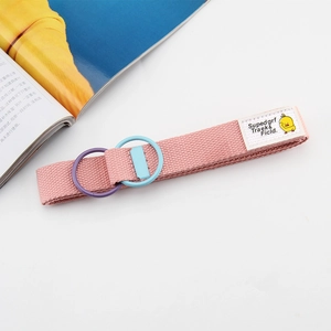Pink canvas belt detail with double D-ring buckle and cute cartoon woven patch