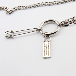 Detail of silver double-layered hip hop waist chain with safety pin and engraved tag