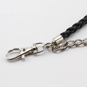 Detail of silver lobster clasp and black braided leather strap on dual-layer hip hop chain