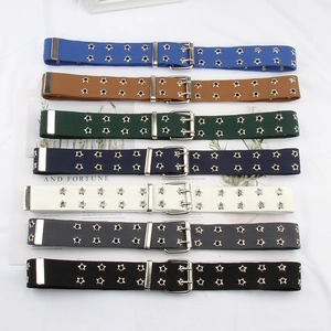 Detail view of colorful canvas belts with double-row star eyelets and silver buckles