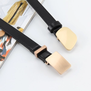 Thin black leather belts for women with stylish gold geometric buckles on white background