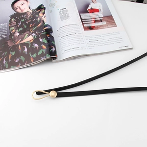 Fine ceinture femme en cuir noir avec élégante boucle dorée en forme de goutte d'eau