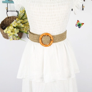 Bohemian woven straw belt with orange resin buckle on white dress for women
