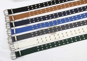 Detail view of colorful canvas belts with double-row star eyelets and silver buckles