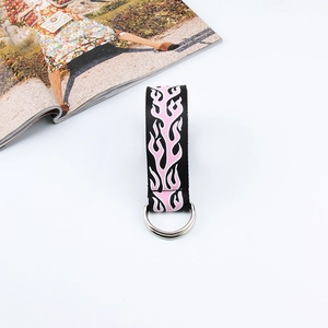 Detail of black nylon belt with pink flame print and silver double D-ring buckle