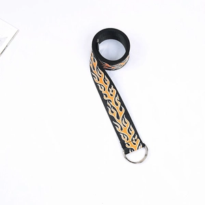 Detail of black canvas belt featuring orange flame print and metal double D-ring buckle