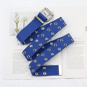 Close-up of navy canvas belt featuring star-shaped metal eyelets and silver buckle