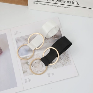 Minimalist elastic canvas belt with double gold rings in classic black and white colors
