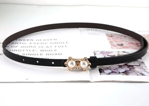 Close-up of black leather slim belt with dual pearl decorative gold buckle for dresses