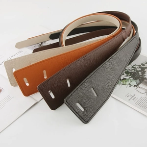 Detail view of four textured leather waist belts in beige, caramel, brown, and black