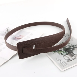 Detailed view of deep brown litchi pattern leather belt with a minimalist wide covered buckle