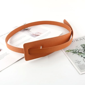 Detail of caramel lychee grain leather belt with a minimalist rectangular buckle