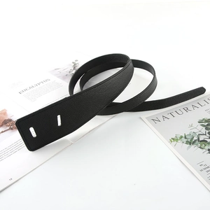 Detail of black lychee texture leather belt strap with double rectangular punch holes