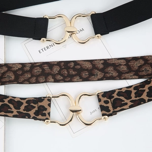 Elastic waist belts in black and leopard print with golden metal interlocking buckles