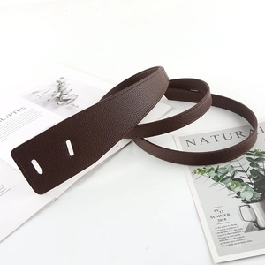 Detailed view of dark brown lychee grain leather belt with double eyelet design
