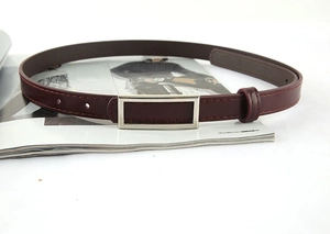 Detailed view of dark burgundy slim leather belt with a silver rectangular metal buckle