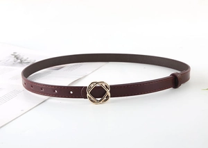 Detail of burgundy slim waist belt with golden metal buckle on clean white background