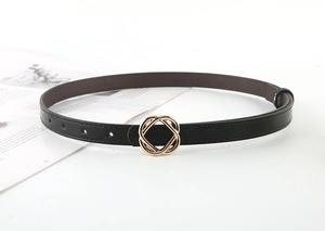 Detail of slim black leather belt with golden wave-shaped buckle for dress decoration