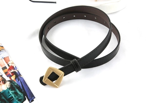 Detail of black leather waist belt with matte gold geometric square buckle and stitching