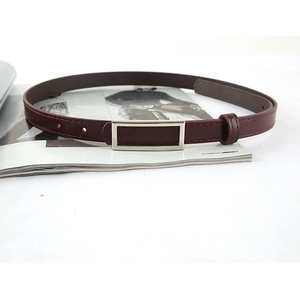 Minimalist women's thin burgundy leather belt with a rectangular silver buckle for jeans