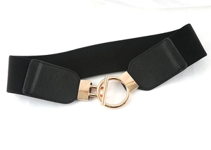 Close-up of black elastic waist belt featuring a gold metal OT buckle and leather ends