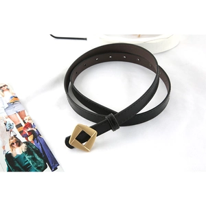 Slim black leather belt with a matte gold square buckle for women over a white background