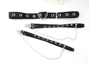Detail view of punk style black PU leather belt set with heart buckle and metal chains