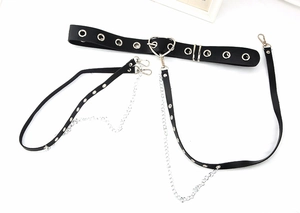 Detail view of black punk body harness with silver heart buckles and detachable chains