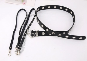 Detail view of punk gothic PU leather belt with heart buckle and silver metal chains