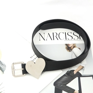 Minimalist black leather belt with heart-shaped silver metal buckle on a white background