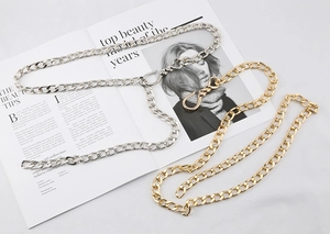 Close-up of chunky gold and silver hip-hop metal chains with flat link design and hooks