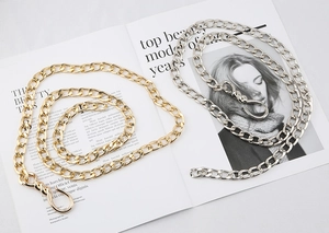Detail of gold and silver chunky metal chains with stylish twist-shaped lobster clasps