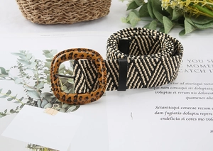 Detail of woven straw belt with bohemian herringbone pattern and leopard print buckle