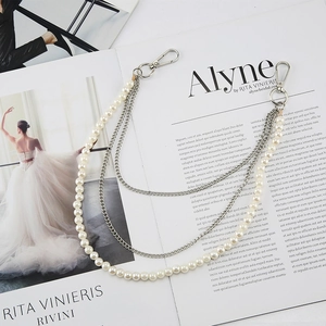 Elegant multi-layer pearl and silver metal chain belt accessory for stylish trousers