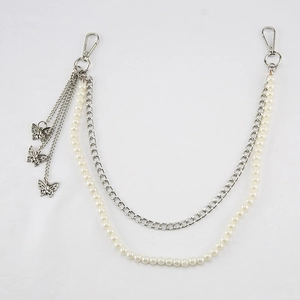 Detail of silver double-layered chain with white pearls and hollow butterfly charms