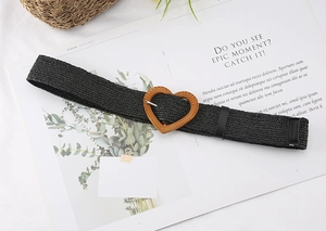 Close-up of black straw woven belt featuring a textured heart buckle and leather tip