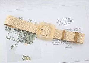 Detailed view of beige woven straw belt with square resin buckle and metal pin