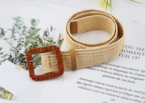 Detail view of beige woven straw belt with a textured brown square buckle for boho dresses