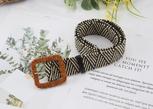Detail of square wood-texture buckle and beige black woven wave pattern straw belt
