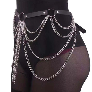 Détail d'une ceinture punk à chaînes multicouches avec similicuir noir et rivets argentés