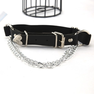 Detail showing a black leather punk choker with bold silver chain and heart charm
