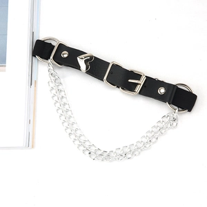 Detail of punk leather leg garter with heart rivets, metal rings and double chains