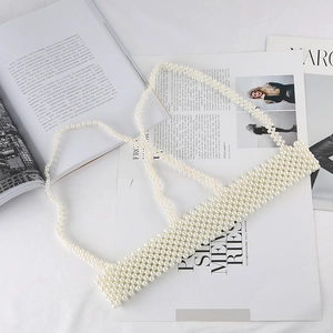 Luxurious white pearl woven camisole top with thin beaded straps on fashion magazine