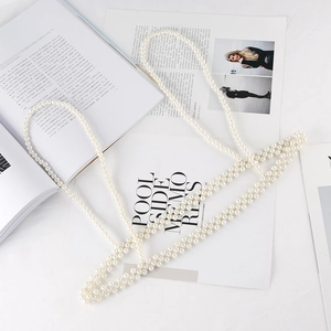 Detailed macro view of multi-layered pearl body chain with elegant white beaded drape