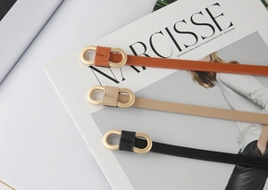 Three slim leather belts in black, brown, and beige with gold double-ring buckles