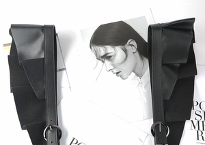 Detail of black PU leather punk waist belt featuring ruffled edges and metal pin buckle