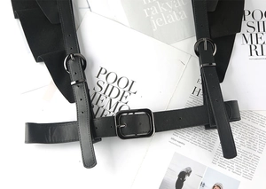 Detail of punk style PU leather body harness with ruffles and adjustable buckles