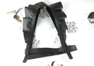 Detail view of black PU leather waist corset featuring tiered ruffle shoulder straps