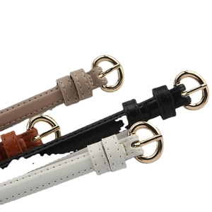 Slim women's leather belts with gold round buckles in tan, black, brown, and white colors