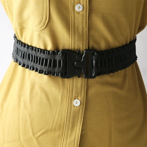 Elastic black cinched waist belt with quick-release tactical buckle on yellow shirt